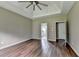 Bedroom with tray ceiling, hardwood floors, and ensuite bathroom at 5036 Weatherstone Drive, Buford, GA 30519