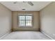 Bedroom with neutral walls, carpet, ceiling fan, and a window at 5036 Weatherstone Drive, Buford, GA 30519