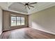 Bedroom with tray ceilings, large window, and hardwood floors at 5036 Weatherstone Drive, Buford, GA 30519