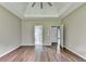 Bedroom with tray ceiling, hardwood floors, and ensuite bathroom at 5036 Weatherstone Drive, Buford, GA 30519