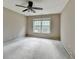 Bedroom with neutral walls, carpet, ceiling fan, and a window at 5036 Weatherstone Drive, Buford, GA 30519