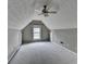 Spacious bonus room featuring neutral walls, plush carpet and vaulted ceiling with ceiling fan at 5036 Weatherstone Drive, Buford, GA 30519