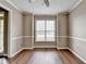 Dining room with hardwood floors, large window, and neutral paint at 5036 Weatherstone Drive, Buford, GA 30519