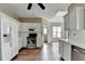 Well-lit kitchen with stainless appliances and white cabinets, adjacent to a spacious area at 5036 Weatherstone Drive, Buford, GA 30519
