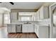 Modern kitchen with white cabinets, stainless steel appliances, and wood floors at 5036 Weatherstone Drive, Buford, GA 30519