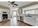 Bright kitchen featuring stainless steel appliances, white cabinets and hardwood floors at 5036 Weatherstone Drive, Buford, GA 30519