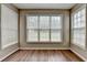 Living room bathed in sunlight, featuring neutral colored walls and hardwood floors at 5036 Weatherstone Drive, Buford, GA 30519
