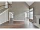 Open living room with fireplace, hardwood floors, and natural light at 5036 Weatherstone Drive, Buford, GA 30519