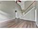 Spacious living room with vaulted ceilings, hardwood floors, and staircase at 5036 Weatherstone Drive, Buford, GA 30519