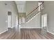 Open living room with hardwood floors, staircase, and ample natural light at 5036 Weatherstone Drive, Buford, GA 30519