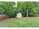 Backyard storage shed with double doors and an easy access ramp at 5036 Weatherstone Drive, Buford, GA 30519