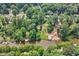 Expansive aerial view of a waterfront property with a private dock and lush greenery at 610 Lake Dr, Snellville, GA 30039