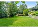 Expansive backyard featuring lush lawn and mature trees offering a private, tranquil setting at 610 Lake Dr, Snellville, GA 30039
