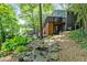 Backyard of home featuring mature landscaping, deck, and stairs at 610 Lake Dr, Snellville, GA 30039