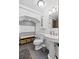 Well-lit bathroom offers a pedestal sink, toilet, storage, and tile floors at 610 Lake Dr, Snellville, GA 30039