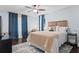 Comfortable bedroom with a queen bed, blue accents, and a ceiling fan at 610 Lake Dr, Snellville, GA 30039