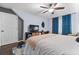 Bright bedroom with ceiling fan, TV, and study area, offering comfort and functionality at 610 Lake Dr, Snellville, GA 30039
