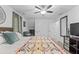 Bright bedroom boasts ample space, ceiling fan, and cozy seating area for relaxation at 610 Lake Dr, Snellville, GA 30039
