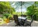 Deck with outdoor seating and an umbrella, overlooking a lush pond at 610 Lake Dr, Snellville, GA 30039