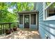 Exterior view of a wooden deck with potted plants and access to a screened porch at 610 Lake Dr, Snellville, GA 30039