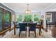 Bright dining room featuring a bay window, hardwood floors, and stylish chandelier at 610 Lake Dr, Snellville, GA 30039