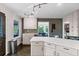 Spacious kitchen with an island, white cabinets, and a view into the dining area at 610 Lake Dr, Snellville, GA 30039