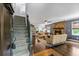 Spacious living room with hardwood floors, fireplace, and stairs at 610 Lake Dr, Snellville, GA 30039