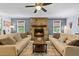 Well-lit living room with a stone fireplace and hardwood flooring at 610 Lake Dr, Snellville, GA 30039
