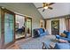 Inviting sunroom with comfortable seating, ceiling fan, and access to an outdoor area at 610 Lake Dr, Snellville, GA 30039