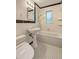 A tiled bathroom featuring a classic pedestal sink, a toilet, and shower-over-tub combo at 1400 Chalmette Ne Dr # 2, Atlanta, GA 30306