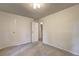 Bedroom with a closet, a door leading to another room, and plain white walls at 1400 Chalmette Ne Dr # 2, Atlanta, GA 30306