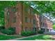 Brick building with lush green trees and lawn at 1400 Chalmette Ne Dr # 2, Atlanta, GA 30306