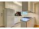 Efficient kitchen space with white appliances, black tile backsplash, and compact cooktop at 1400 Chalmette Ne Dr # 2, Atlanta, GA 30306