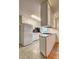 Functional kitchen area with white appliances, black backsplash, and small cooktop at 1400 Chalmette Ne Dr # 2, Atlanta, GA 30306