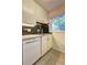 Well-maintained kitchen featuring white cabinets, stainless steel sink, and black tile backsplash at 1400 Chalmette Ne Dr # 2, Atlanta, GA 30306