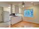 Bright eat-in kitchen features hardwood floors, window view, and white appliances with glass shelves at 1400 Chalmette Ne Dr # 2, Atlanta, GA 30306
