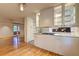Eat-in kitchen featuring hardwood floors, white cabinets with glass shelves, and a view into the living room at 1400 Chalmette Ne Dr # 2, Atlanta, GA 30306