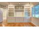 Living room with hardwood floors features built-in bookshelves and a large window at 1400 Chalmette Ne Dr # 2, Atlanta, GA 30306