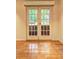 Patio doors overlooking fenced yard and a shiny hardwood floor at 1400 Chalmette Ne Dr # 2, Atlanta, GA 30306