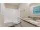 Bathroom featuring granite vanity top with cabinet, modern fixtures, toilet, and shower-tub combo at 1496 Indian Forest Ct, Stone Mountain, GA 30083