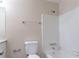 This bathroom features a white tile shower-tub combo and a matching toilet at 1496 Indian Forest Ct, Stone Mountain, GA 30083