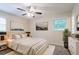 Cozy bedroom featuring neutral decor, ceiling fan and windows providing natural light at 1496 Indian Forest Ct, Stone Mountain, GA 30083