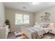 A cozy bedroom decorated with shelves, a bed, and a dresser at 1496 Indian Forest Ct, Stone Mountain, GA 30083