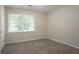 This bedroom features neutral walls, plush carpet, and a window with natural light at 1496 Indian Forest Ct, Stone Mountain, GA 30083