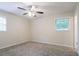 A simply designed bedroom featuring neutral walls, carpet, and windows for natural light at 1496 Indian Forest Ct, Stone Mountain, GA 30083