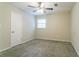 This bedroom includes a ceiling fan, plush carpet, and a window with natural light at 1496 Indian Forest Ct, Stone Mountain, GA 30083