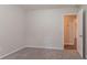 The bedroom features neutral walls, carpet, and an open doorway leading to an adjacent room at 1496 Indian Forest Ct, Stone Mountain, GA 30083