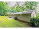 Side exterior view of a brick home featuring a patio and air conditioning unit at 1496 Indian Forest Ct, Stone Mountain, GA 30083