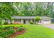 Charming one-story home featuring a well-manicured lawn and attached garage at 1496 Indian Forest Ct, Stone Mountain, GA 30083
