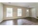 Inviting living room with wood floors and windows providing natural light at 1496 Indian Forest Ct, Stone Mountain, GA 30083